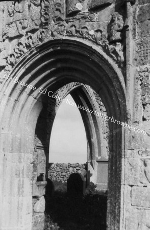 CLONTUSKERT PRIORY LOOKING THROUGH W.DOOR SHOWING FONT & TRANSEPT AISLE